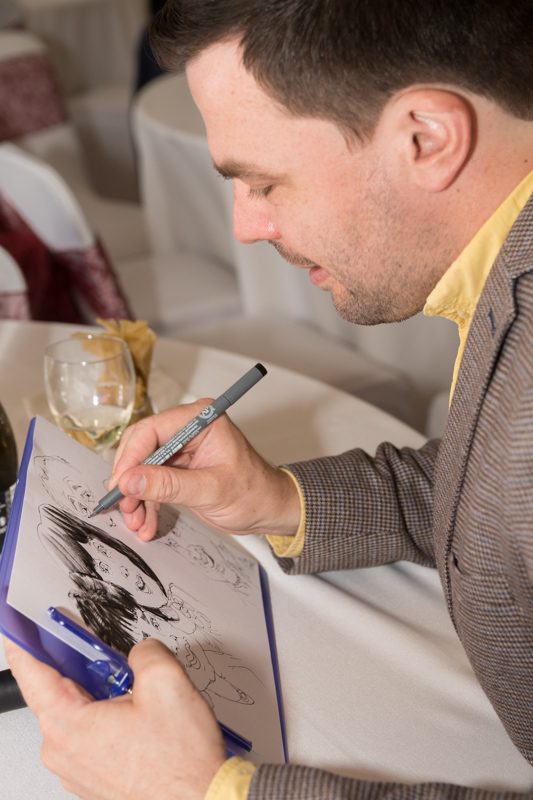 Birmingham UK Caricaturist Pen Jones drawing a caricature