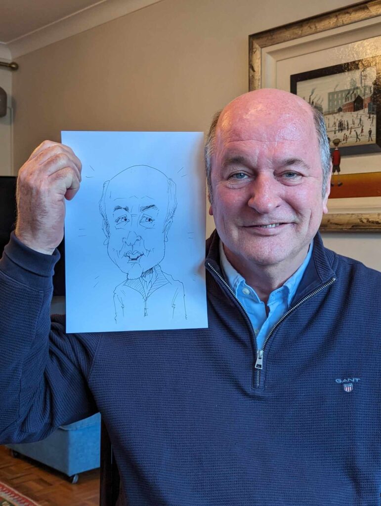 A man holding his caricature at a Birthday party in London