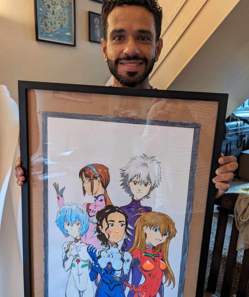 A happy customer holding a  framed anime themed caricature by pen jones caricaturist